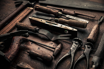 carpenter's old tools closeup on wooden workbench