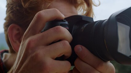 Closeup photographer hands take picture on photo camera. Tourist film nature.