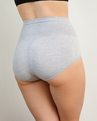 Close up portrait of a naked woman body in gray panties plus size, underwear