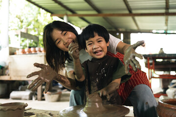 Happy family moment Mother and little boy crafting pottery clay workshop. Child creative activities and art. Kid playing modeling clay in pottery workshop. Developing children's learning skills.
