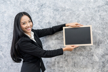 business woman holding blank black board,Blank black board template for insert text and graphic,empty black board mock up,selective focus.