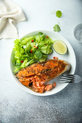 Roasted salmon steak with green salad