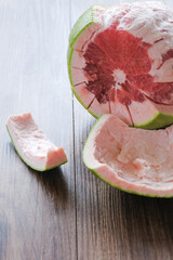 Fresh red pomelo fruit or grapefrui on wooden background