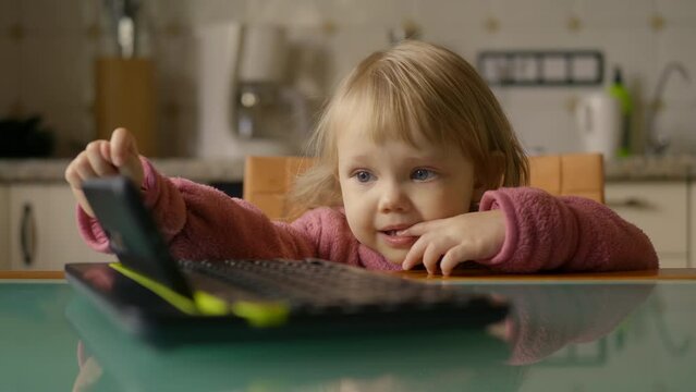Ukrainian child playing with a tablet. High quality 4k footage