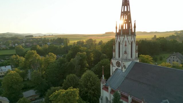 Drone look to gothic revival style Catholic church in small town Chrastava in the North of the Czech Republic during sunset