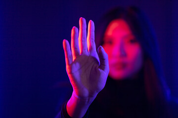 Stylish sexy woman in trendy. Beautiful young asian woman standing pose with neon light. Asia Pretty asian female in the dark room. Fashion shot.