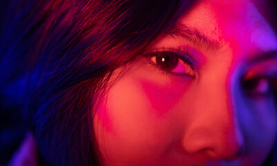 Stylish sexy woman in trendy. Beautiful young asian woman standing pose with neon light. Asia Pretty asian female in the dark room. Fashion shot.