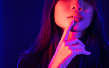 Stylish sexy woman in trendy. Beautiful young asian woman standing pose with neon light. Asia Pretty asian female in the dark room. Fashion shot.