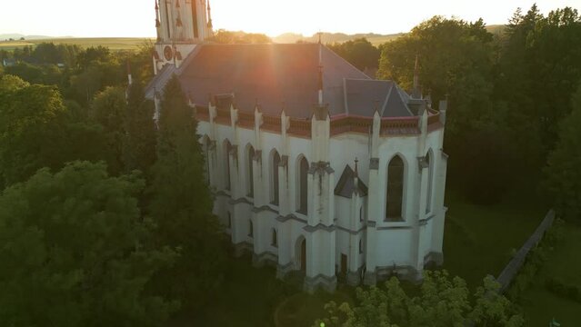 Drone look to gothic revival style Catholic church in small town Chrastava in the North of the Czech Republic during sunset