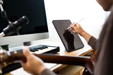 Close up hands song writer composing music note on tablet. Professional composer Recording Mixing...