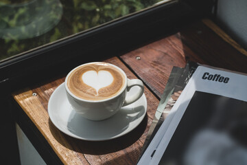 hot coffee with heart latte art shape on wood table,morning cup for freshness concept.