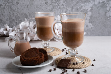 Latte made from chocolate oat milk and natural coffee for two people with dessert.