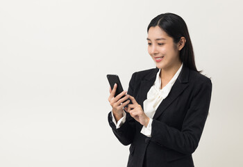 Happy young asian business woman using smartphone on isolated white background. Attractive female...