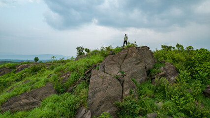 Fototapeta premium Man climbing up hills, feeling strong and powerful, self improvement, success, and life goals concept.