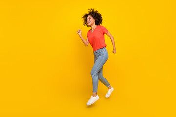 Fototapeta na wymiar Full length profile portrait of crazy cheerful lady look run empty space isolated on yellow color background