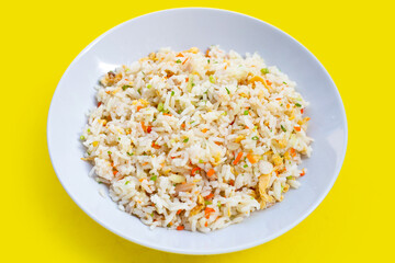 Crab fried rice on white plate on yellow background.