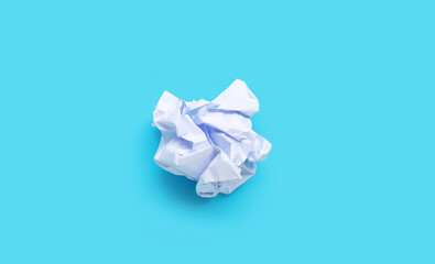 White crumpled paper balls on blue background. Ideas and creative thinking concept. Copy space