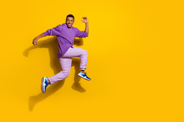 Fototapeta na wymiar Full length body size view of attractive trendy cheerful guy jumping running ad copy space isolated on bright yellow color background