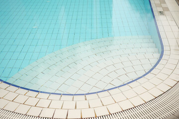 an empty swimming pool with poll stair
