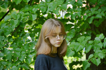 the girl is photographed near the greenery, portrait