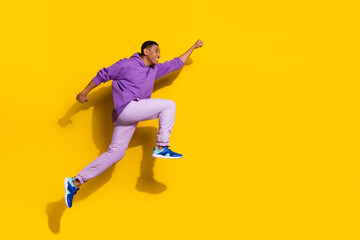 Fototapeta na wymiar Full length body size view of handsome trendy strong cheerful guy jumping striving isolated on vivid yellow color background