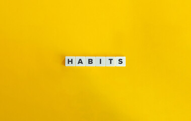 Habits Word on Letter Tiles on Yellow Background. Minimal Aesthetics.