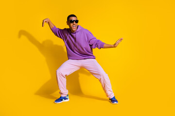 Fototapeta na wymiar Full length body size view of attractive cheerful guy fooling dancing clubbing isolated over bright yellow color background