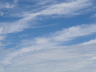 The sky background is a blue sky with white clouds. Cirrus clouds on a blue sky in summer for background