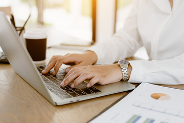 Close up business hands typing on laptop keyboard. Business hands surfing the internet.