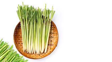 Fresh lemongrass in wooden bamboo threshing basket on white background.