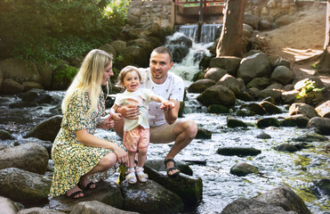 Happy family resting in a summer park