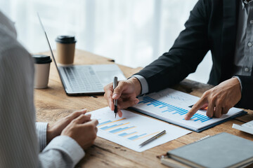 Business people working in the office discussing documents and ideas at meeting, Asian business advisor meeting to analyze and discuss the situation on the financial report.