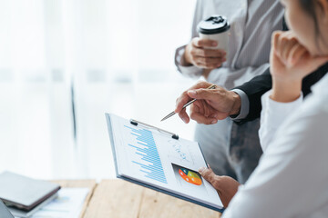 Business people working in the office discussing documents and ideas at meeting, Asian business advisor meeting to analyze and discuss the situation on the financial report.