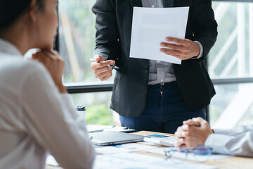 Business people working in the office discussing documents and ideas at meeting, Asian business advisor meeting to analyze and discuss the situation on the financial report.