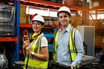 Portrait of team automation engineer smiling hold device in modern industrial factory.