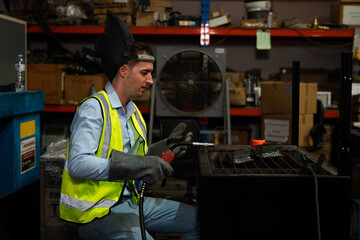 Male technician worker working in the factory, Welder is working to weld metal. 