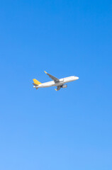 Fototapeta na wymiar Airplane flying on blue sky background. Aircraft isolated on sky
