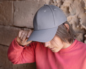 Teenager girl in grey baseball cap and long sleeve shirt outdoor, mockup