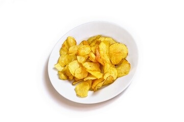 Crispy golden chips on a white plate. Salty snack for beer. Top view food photography for design