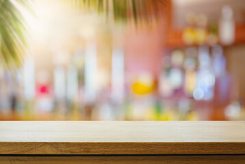Art Empty wooden table on sunny blurred tropical bar background. Outdoor party mockup for design and product display. - obrazy, fototapety, plakaty