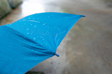 Rain drops on a blue umbrella