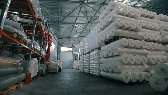 Lots of big rolls of spunbond. Warehouse with rolls of nonwovens. Large warehouse in the nonwovens factory. industrial interior