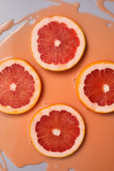 Fototapeta na wymiar Top view of fresh slice grapefruits juice and gel serum, organic cosmetics,