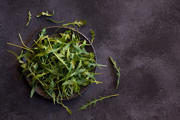 Obraz na płótnie Canvas Fresh arugola leaves, delicious and healthy salad ingredient