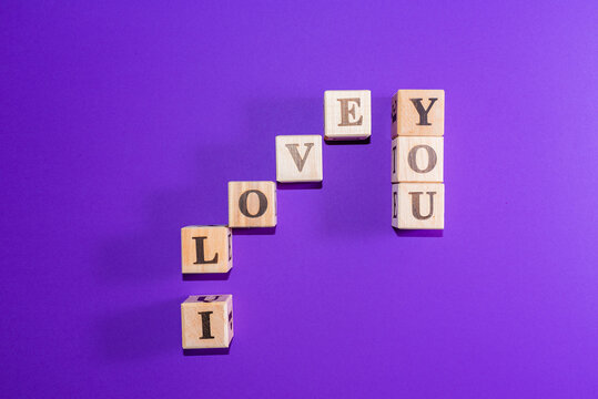 Message I love you spelled in wooden blocks with copy space,Purple,veri peri background.