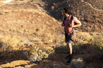 Tourist man hiker on top of the mountain. Active life concept..