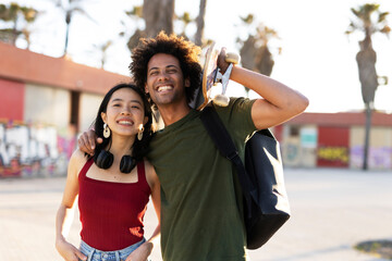 Boyfriend and girlfriend with skateboard. Happy couple enjoy in sunny day