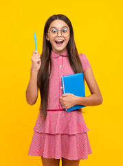 Schoolgirl with copy book posing on isolated background. Literature lesson, grammar school. Intellectual child reader.
