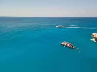 aerial view of porto katsiki beach with cruise boat people having fun