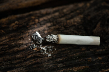 Cigarette with marijuana on an old wood background.
